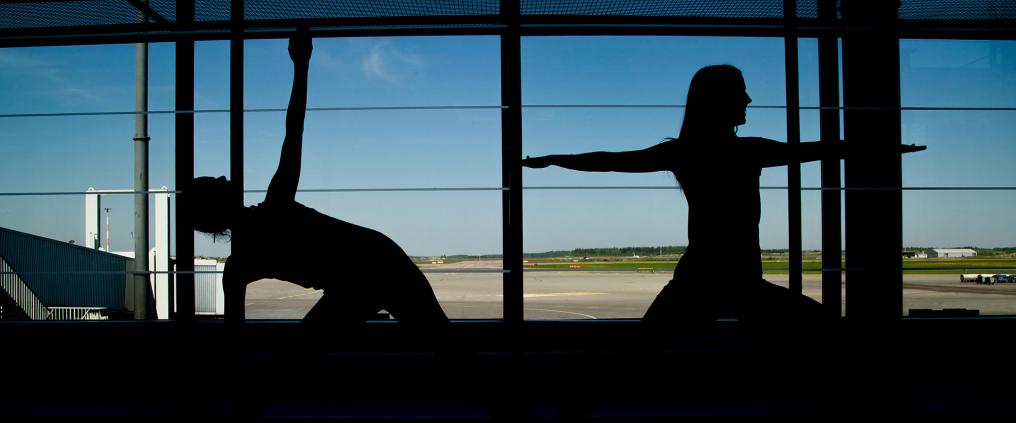 Silhouettes of persons doing yoga.