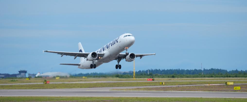 Finnair airplane is taking off runway.