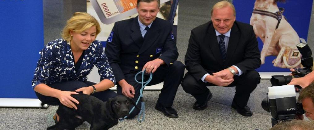 Customs employees with a new puppy.