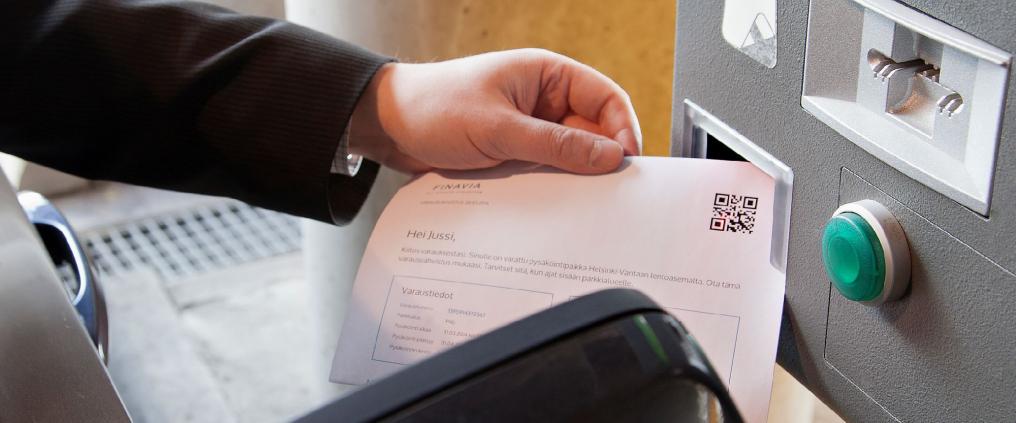 A man showing a receipt to a scanner.