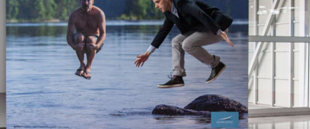 A man jumping into a lake.