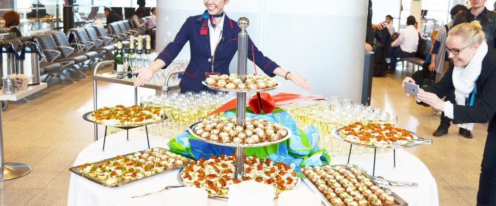A table holding many different types of small foods and drinks.