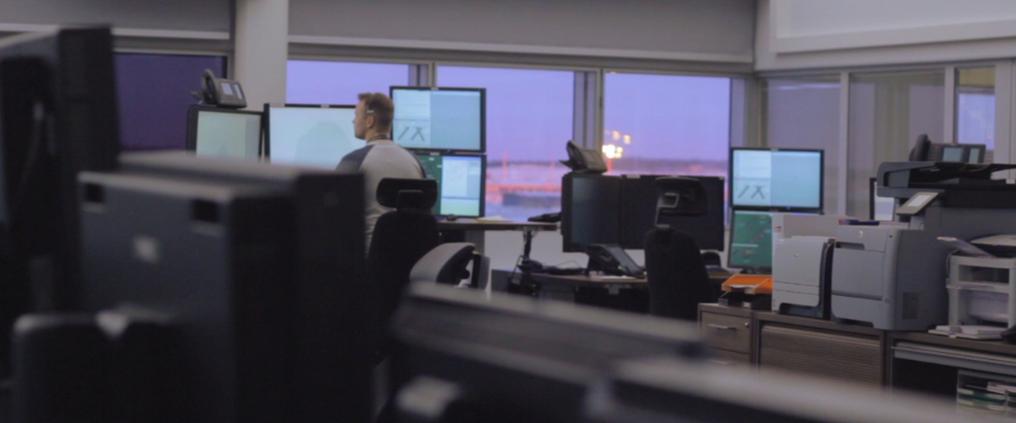 Air traffic controller working with multiple of monitors.