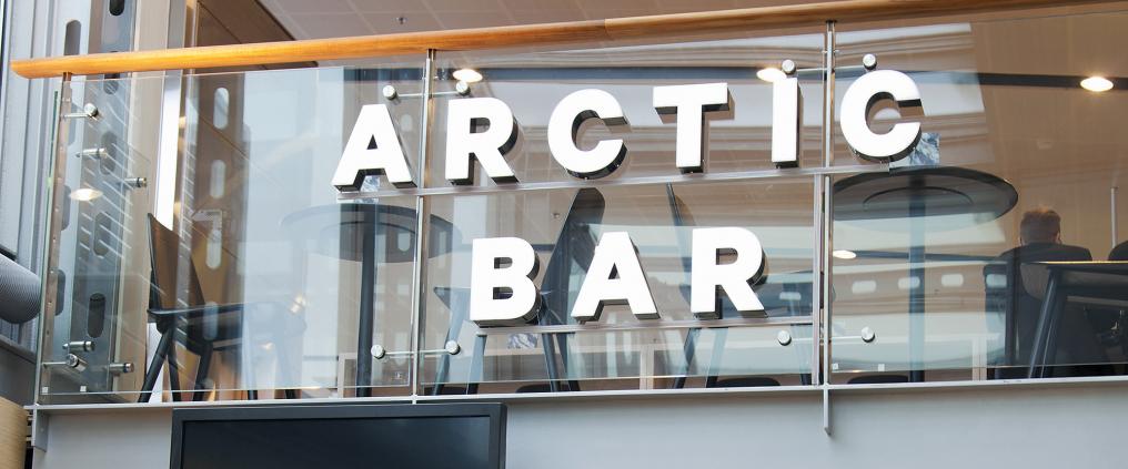 Arctic Bar sign on a glass railing 