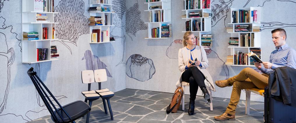 Passenger sitting at book swap.