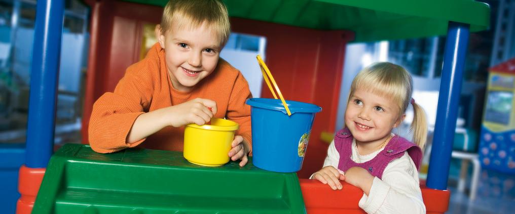 Two childen playing at plaroom.