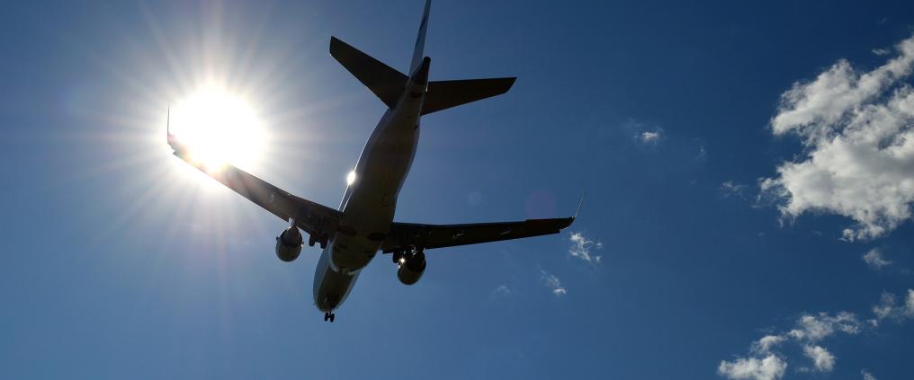A silhouette of a landing airplane.