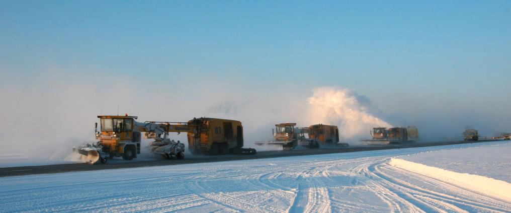 Snowplow machines on snowy day.