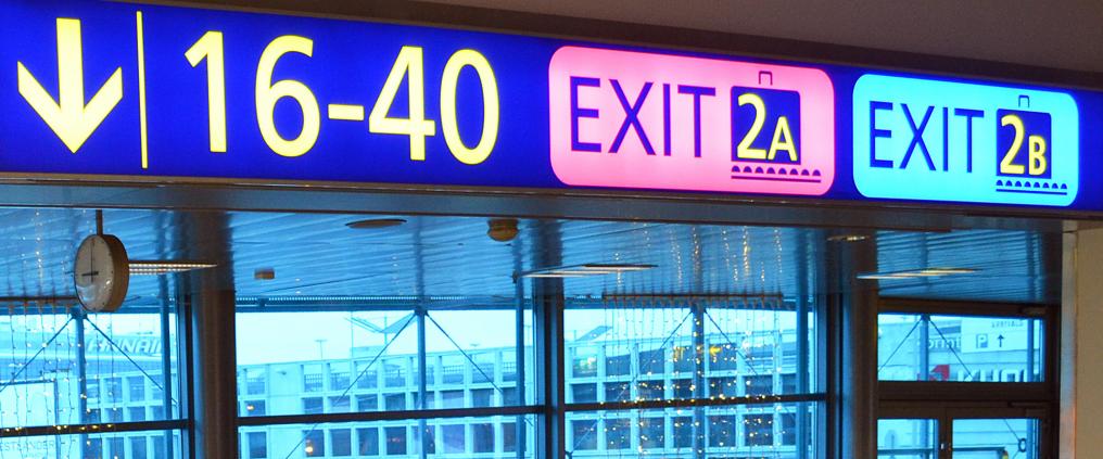 Exit signs at Helsinki Airport.