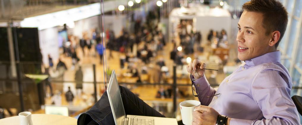 Passenger working from a cafe while drinking coffee.