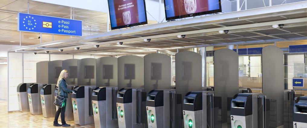 Woman going through automated passport control.