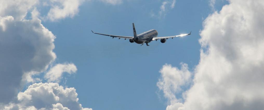 Airplane ascending into sky.