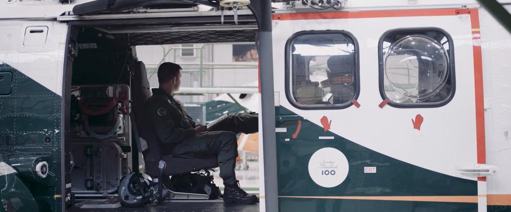 A man sitting inside a helicopter.