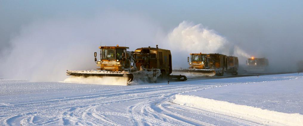 Snowplow machines on snowy day.
