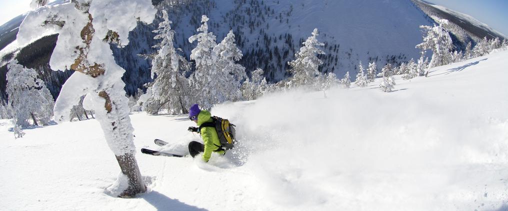 Person skiing down slopes.