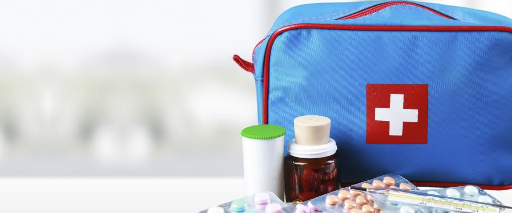 Different medicines in front of a medicine bag.