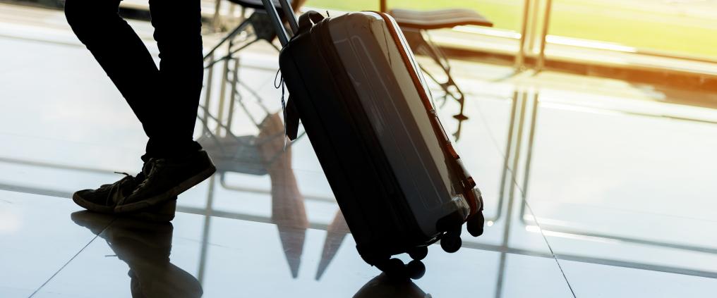 Close up of carry on rolling by passenger.