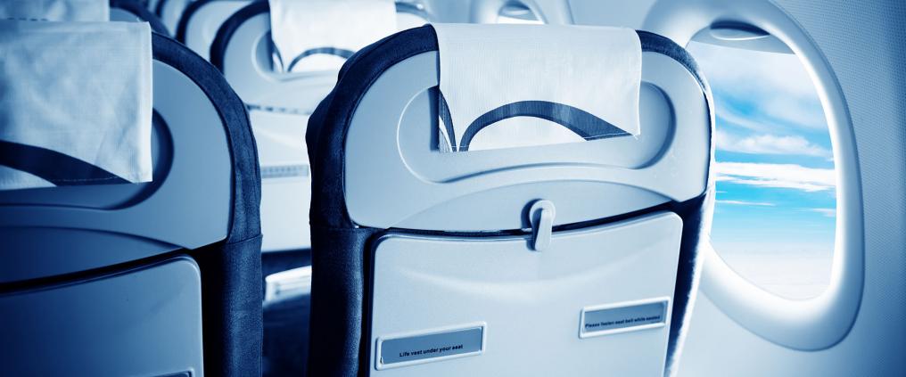 Backside of the seats in an airplane.