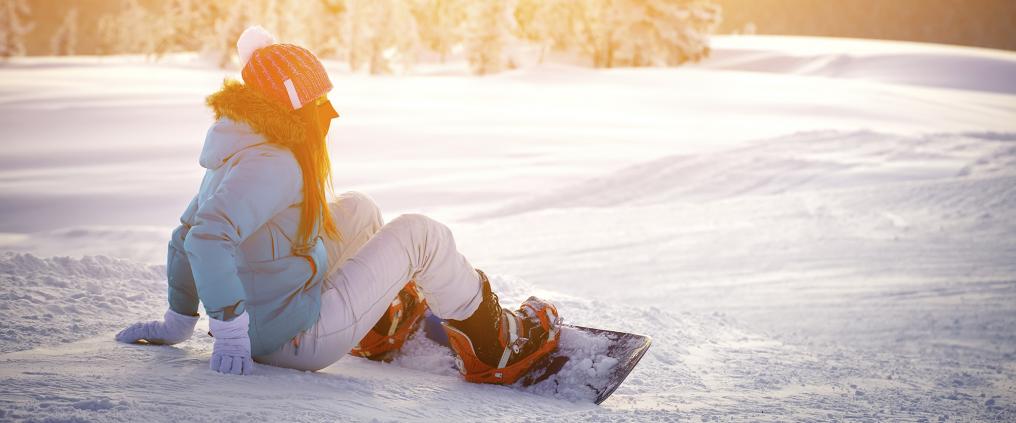 A woman snowboarding.