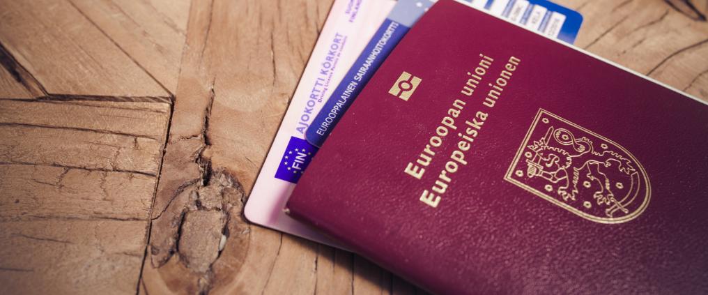 Finnish passport with European Health Insurance Card and finnish driver's licence stuck between the pages.