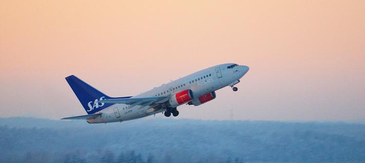 Scandinavian Airlines airplane taking off.